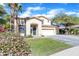 Two-story house with a landscaped front yard and palm trees at 14462 W Avalon Dr, Goodyear, AZ 85395