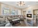 Relaxing Gathering room boasts a fireplace and large sectional sofa at 14462 W Avalon Dr, Goodyear, AZ 85395