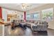 Open Gathering room with kitchen views and dark hardwood floors at 14462 W Avalon Dr, Goodyear, AZ 85395