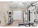 Well-equipped home gym with weight machine and elliptical at 14462 W Avalon Dr, Goodyear, AZ 85395