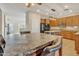Eat-in kitchen with an island, granite countertops, and stainless steel appliances at 14462 W Avalon Dr, Goodyear, AZ 85395