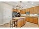Kitchen island with granite countertops and wooden cabinets at 14462 W Avalon Dr, Goodyear, AZ 85395