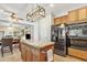 Open kitchen with an island and breakfast bar at 14462 W Avalon Dr, Goodyear, AZ 85395