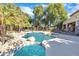 Inviting backyard pool with a waterfall feature and spacious patio area at 14462 W Avalon Dr, Goodyear, AZ 85395