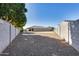 Gravel backyard with view of home and fence at 22703 N 121St Dr, Sun City, AZ 85373