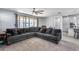 Living room with sectional sofa and sliding glass doors to backyard at 22703 N 121St Dr, Sun City, AZ 85373