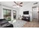 Bright living room with tile floors, a comfortable couch, and a TV at 3030 S Alma School Rd # 12, Mesa, AZ 85210