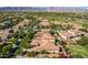 Aerial view of a community with houses, green areas, and mountain backdrop at 3525 N Carlton St, Buckeye, AZ 85396