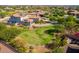 Aerial view of a house with a large yard and a golf course in the background at 3525 N Carlton St, Buckeye, AZ 85396