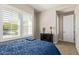 Cozy bedroom with blue bedding and plenty of natural light at 3525 N Carlton St, Buckeye, AZ 85396
