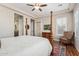 Spacious main bedroom with a large bed, a TV, and access to bathroom at 3525 N Carlton St, Buckeye, AZ 85396