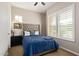 Comfortable bedroom with blue bedding and plantation shutters at 3525 N Carlton St, Buckeye, AZ 85396