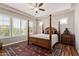 Main bedroom with a four-poster bed, plantation shutters, and hardwood floors at 3525 N Carlton St, Buckeye, AZ 85396