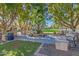 Community courtyard with benches, fountain, and mature trees providing shade at 3525 N Carlton St, Buckeye, AZ 85396
