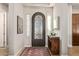 Elegant entryway with arched doorway and wood console table at 3525 N Carlton St, Buckeye, AZ 85396