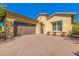 Stunning desert home exterior with a three-car garage and paver driveway at 3525 N Carlton St, Buckeye, AZ 85396