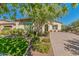 Landscaped front yard with mature trees and brick paver driveway at 3525 N Carlton St, Buckeye, AZ 85396