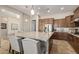 Modern kitchen with granite countertops, stainless steel appliances, and an island with seating at 3525 N Carlton St, Buckeye, AZ 85396