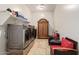 Laundry room with washer, dryer, shelving, and comfortable seating at 3525 N Carlton St, Buckeye, AZ 85396