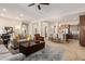 Open living room features a neutral color palette, plush seating, and a view into the kitchen at 3525 N Carlton St, Buckeye, AZ 85396