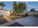 Backyard with grassy area, paved patio, and gravel pathway at 3743 W Dailey St, Phoenix, AZ 85053