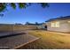 Backyard view of a patio, grassy area, and block wall at 3743 W Dailey St, Phoenix, AZ 85053