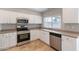 Kitchen with stainless steel appliances and white cabinets at 3743 W Dailey St, Phoenix, AZ 85053