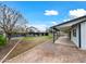 Large backyard with a covered patio, grassy area, and mature trees at 394 E Redfield Rd, Chandler, AZ 85225