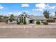 Modern home exterior with a long driveway and a white fence at 394 E Redfield Rd, Chandler, AZ 85225