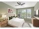 Spacious bedroom with large windows, nightstands, and ceiling fan at 731 E Verde Blvd, Queen Creek, AZ 85140