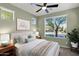 Comfortable bedroom with large window, nightstand, and ceiling fan at 731 E Verde Blvd, Queen Creek, AZ 85140