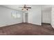 Large bedroom with ceiling fan, ample closet space and carpet at 8106 N 31St Dr, Phoenix, AZ 85051