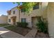 Front view of a tan stucco condo building with walkway and landscaping at 8106 N 31St Dr, Phoenix, AZ 85051
