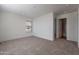 Well-lit bedroom with carpeted floor, window blinds, and access to bathroom at 249 N 89Th St, Mesa, AZ 85207
