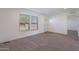 Spacious living room featuring neutral walls, carpet, and a view of the front yard at 249 N 89Th St, Mesa, AZ 85207