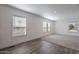 Living area with hardwood floors, carpeted area, and multiple windows at 249 N 89Th St, Mesa, AZ 85207