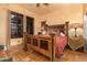 Bedroom with wooden bed, tiled floors, and window shutters at 2912 E Vaughn Ave, Gilbert, AZ 85234