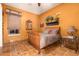 Bedroom with wooden bed and an orange color scheme at 2912 E Vaughn Ave, Gilbert, AZ 85234