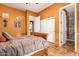 Bedroom with wooden bed and ensuite bathroom at 2912 E Vaughn Ave, Gilbert, AZ 85234