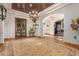 Grand entryway with a large chandelier and double doors at 2912 E Vaughn Ave, Gilbert, AZ 85234