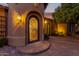 Elegant entryway with ornate iron door and welcoming exterior lighting at 2912 E Vaughn Ave, Gilbert, AZ 85234