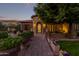 Inviting front entrance with a stone walkway and lush landscaping at 2912 E Vaughn Ave, Gilbert, AZ 85234