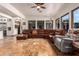 Spacious Gathering room with comfortable leather sectional and tile flooring at 2912 E Vaughn Ave, Gilbert, AZ 85234