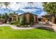 Landscaped yard with lush greenery, stone walkway, and fountain at 2912 E Vaughn Ave, Gilbert, AZ 85234