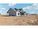 Rear view of a charming farmhouse with stone and siding details at 300 S Charleston Ct, Casa Grande, AZ 85194