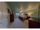 Primary bedroom with a large bed and built-in dresser at 664 W Jardin Dr, Casa Grande, AZ 85122