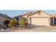 House exterior featuring a two-car garage and desert landscaping at 664 W Jardin Dr, Casa Grande, AZ 85122