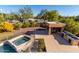 Large backyard with a pool, spa, and outdoor kitchen at 9382 E Aster Dr, Scottsdale, AZ 85260