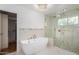 Spa-like bathroom featuring a soaking tub, walk-in shower, and modern finishes at 9382 E Aster Dr, Scottsdale, AZ 85260