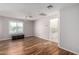 Large bedroom with wood floors, a ceiling fan, and access to bathroom at 9382 E Aster Dr, Scottsdale, AZ 85260